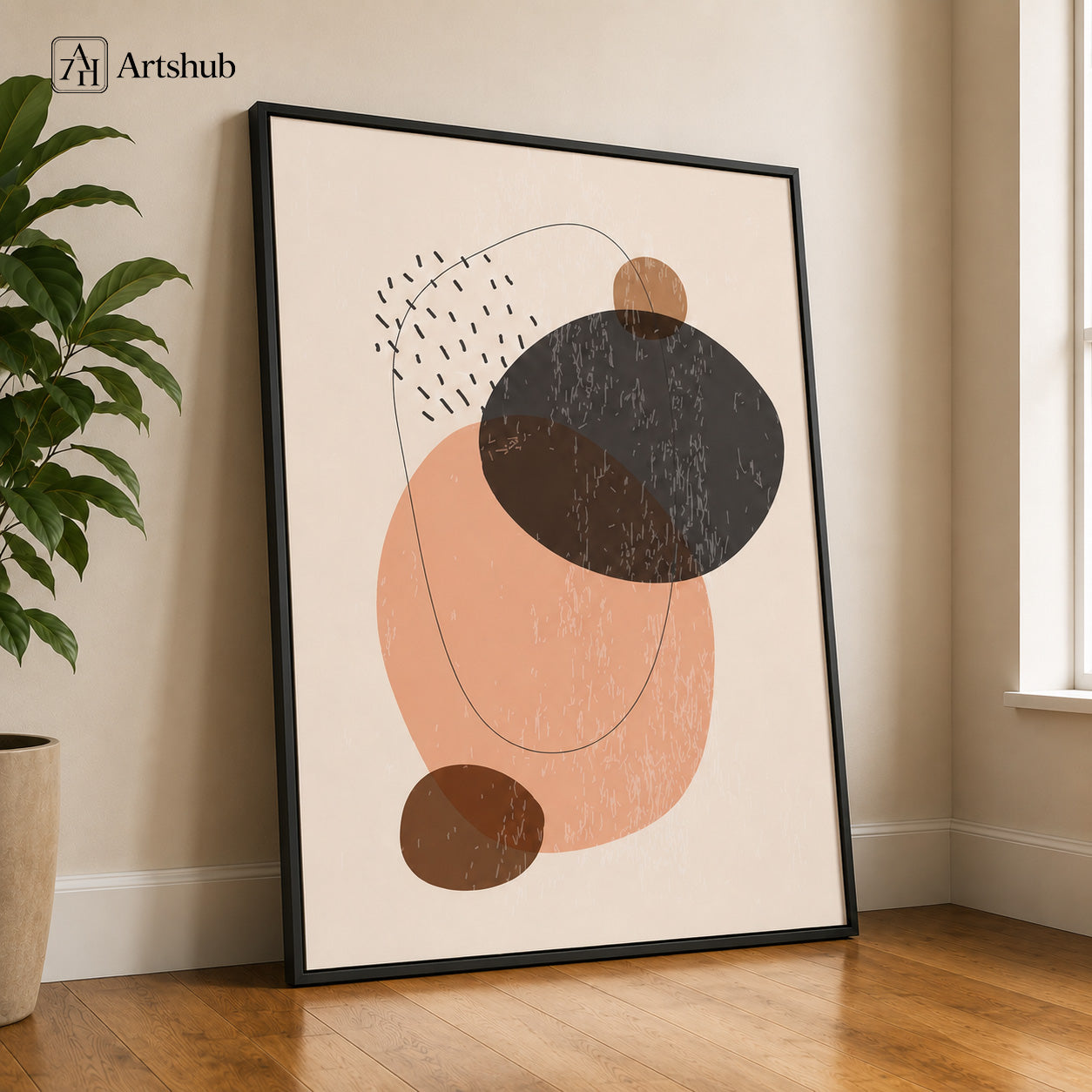 Artshub Quiet Form Blush Peach Charcoal Brown Abstract Oval Minimal single panel framed canvas wall art leaning on warm cream wall on oak floor with large green fiddle leaf fig plant natural window light — blush peach charcoal brown matte black frame