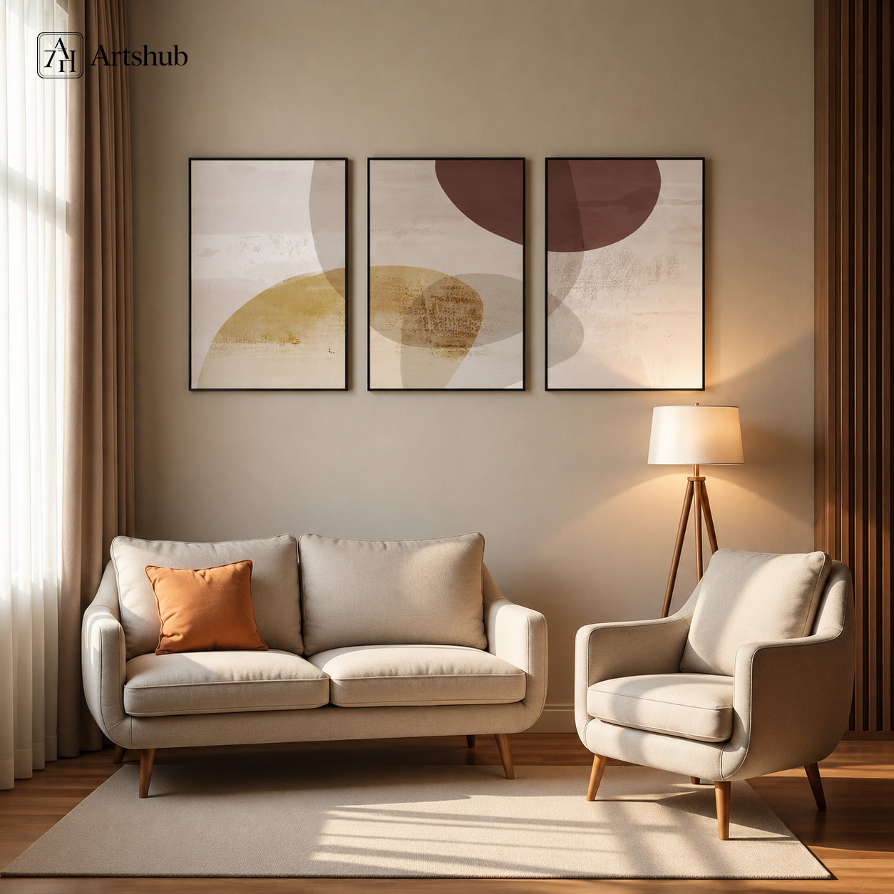 Artshub Terra Drift 3-panel triptych abstract canvas framed wall art displayed on a warm beige wall above a cream sofa with orange cushion and cream armchair, tripod floor lamp with white shade, natural light from window with sheer curtains and warm wood floor – overlapping abstract circles in terracotta, gold and beige in black floater frames