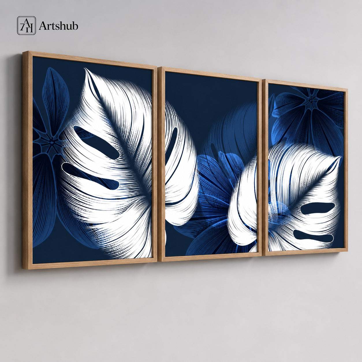 Artshub Navy Blue Monstera Leaf triptych 3 panel framed canvas wall art on grey wall above cream sofa — white monstera leaves navy blue oak frame living room