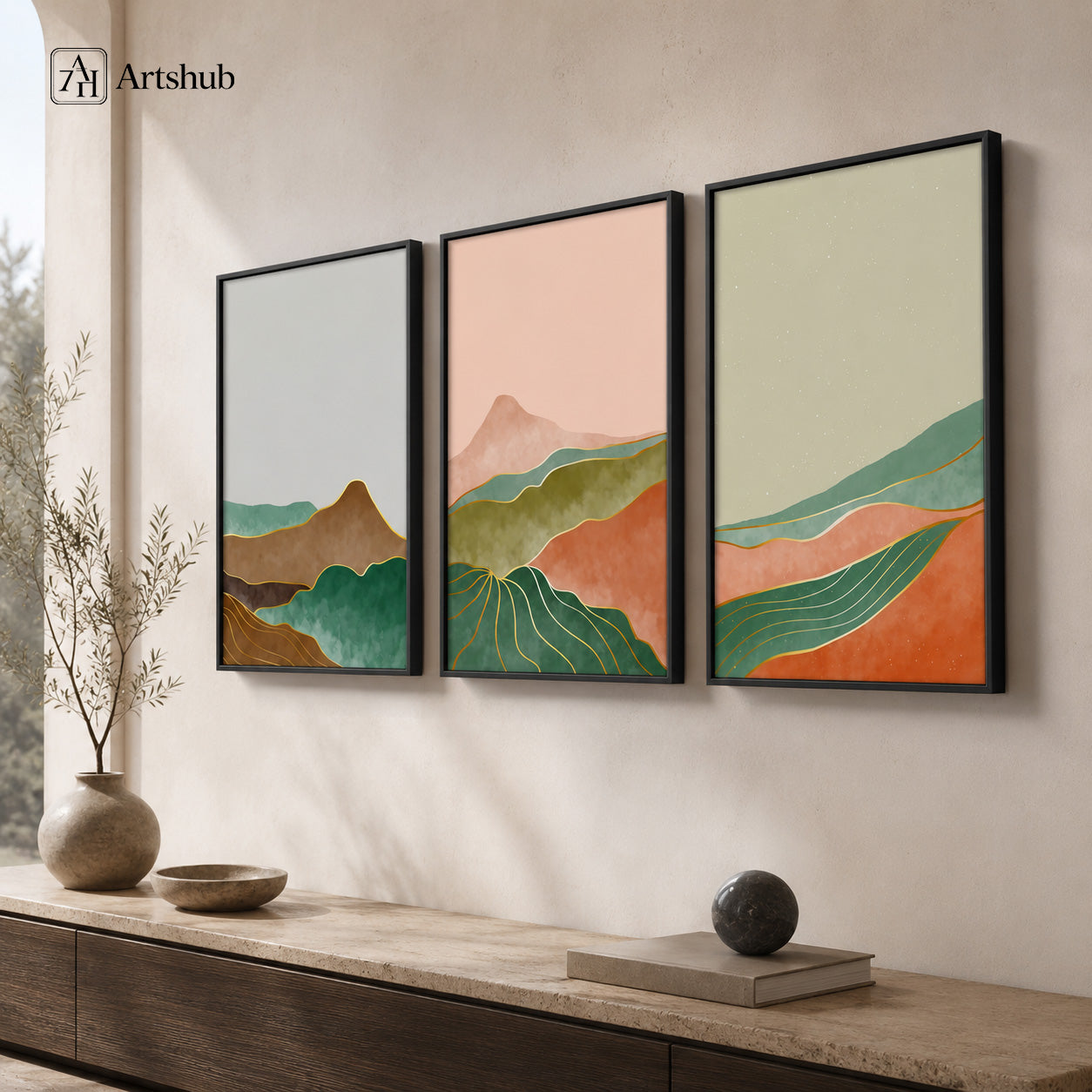 Artshub Curated Landscapes Blush Pink Forest Green Terracotta Mountain Valley triptych 3 panel framed canvas wall art in warm Japandi living room above travertine console with ceramic bowl and black sphere — blush pink green terracotta matte black frame