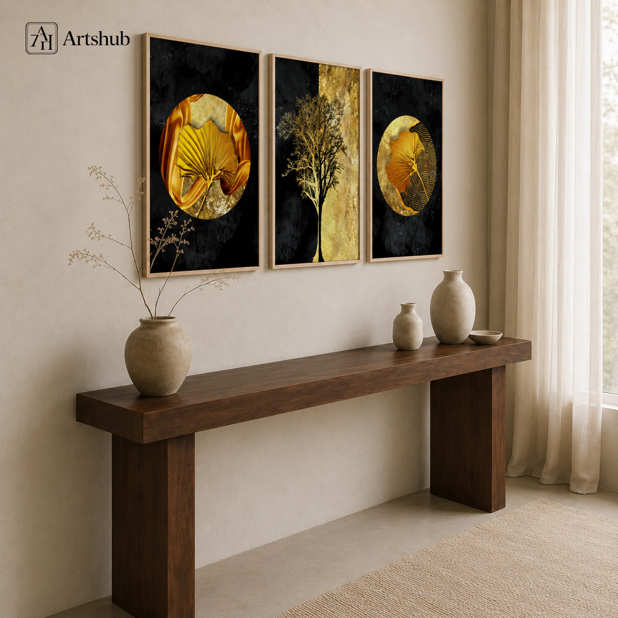 Artshub Golden Orbit 3-panel triptych canvas framed wall art displayed on a warm beige wall above a dark solid wood console table with large ceramic vase with dried branches, two cream ceramic vases and small ceramic bowl, sheer white curtains and natural light – golden ginkgo and tree triptych in natural wood floater frames