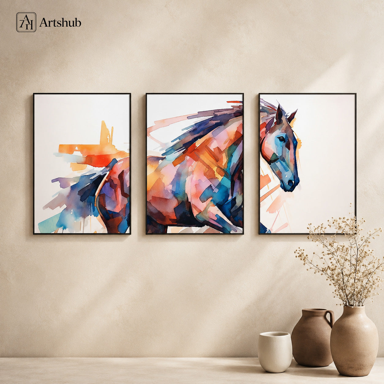 Artshub Watercolour Abstract Horse triptych 3 panel framed canvas wall art on warm beige wall above terracotta vases with dried grass — orange teal blue pink matte black frame