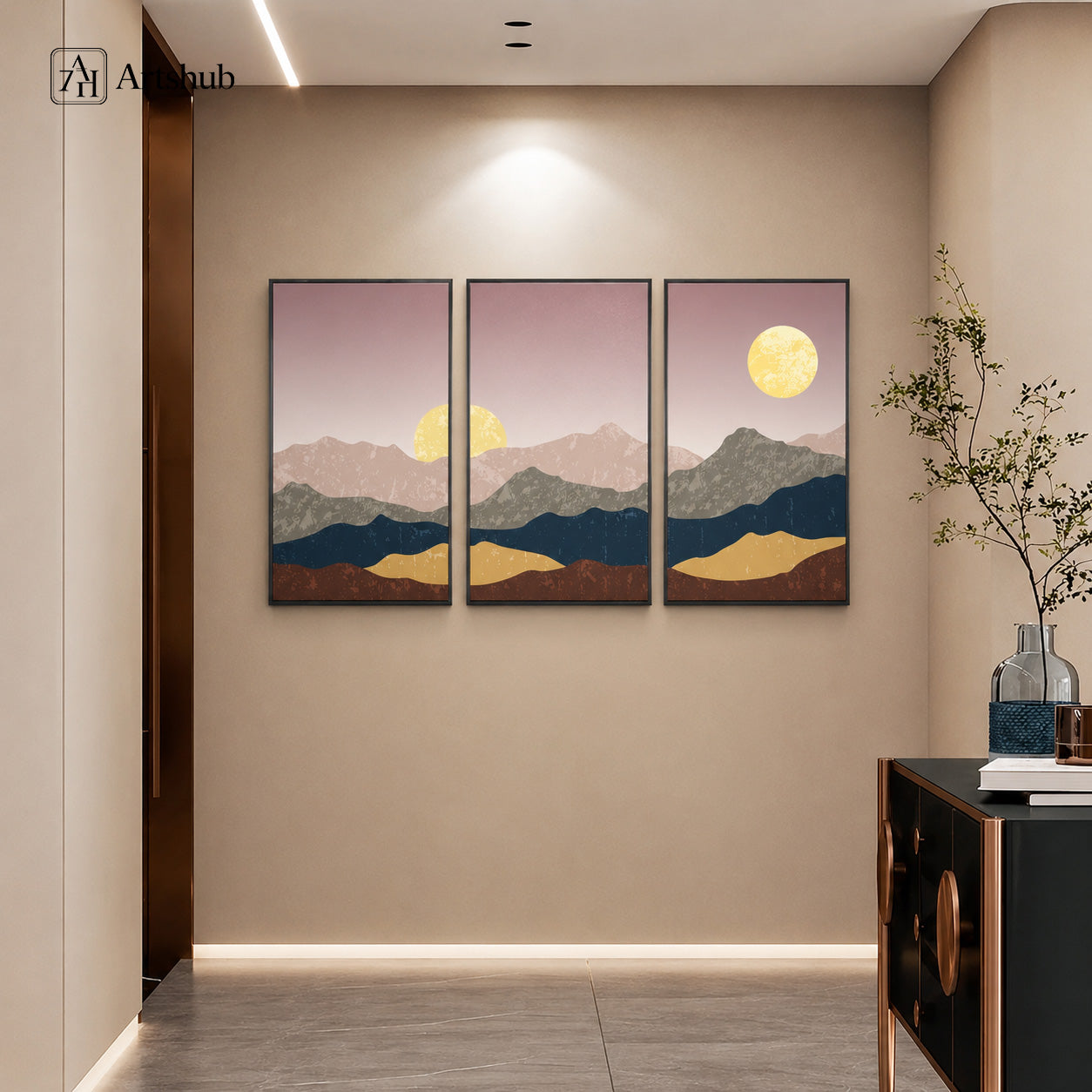 Artshub Timeless Landscapes Dusty Rose Teal Gold Mountain Moonrise triptych 3 panel framed canvas wall art in warm beige entryway corridor above black gold console with glass vases — dusty rose teal gold matte black frame