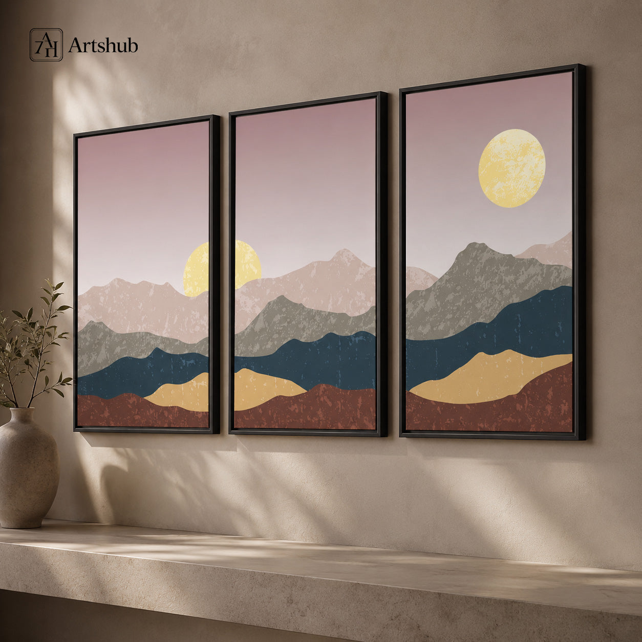 Artshub Timeless Landscapes Dusty Rose Teal Gold Mountain Moonrise triptych 3 panel framed canvas wall art on warm cream wall above marble ledge with ceramic vase dried branches — dusty rose teal gold matte black frame